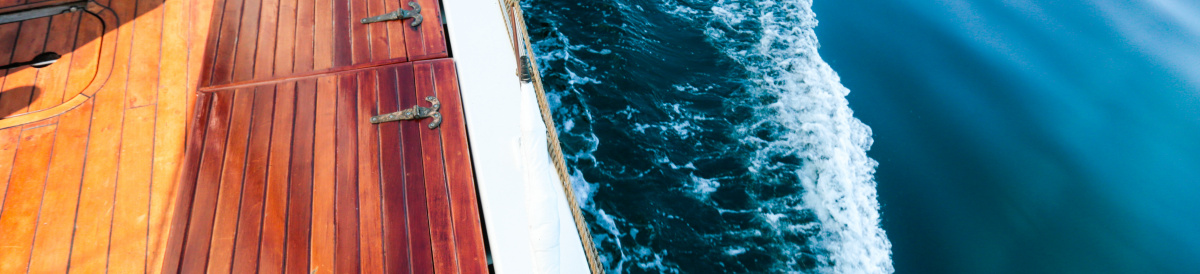 Looking down at the deck of the Bluenose II and the sea.